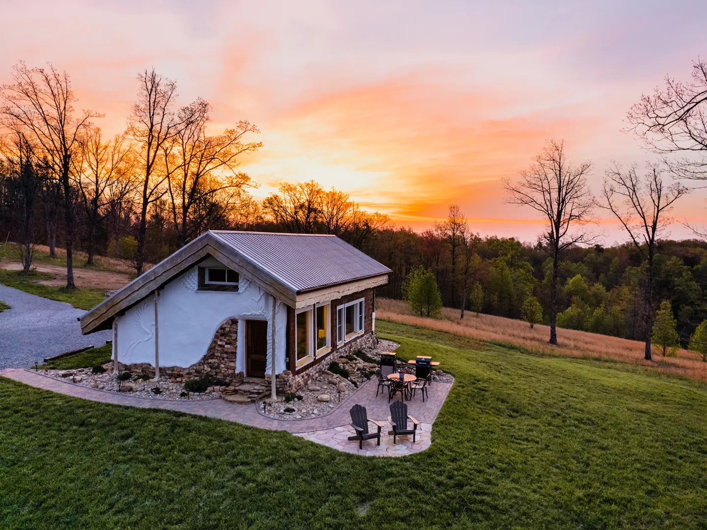 A Tennessee cabin and outdoor gathering space at sunset.