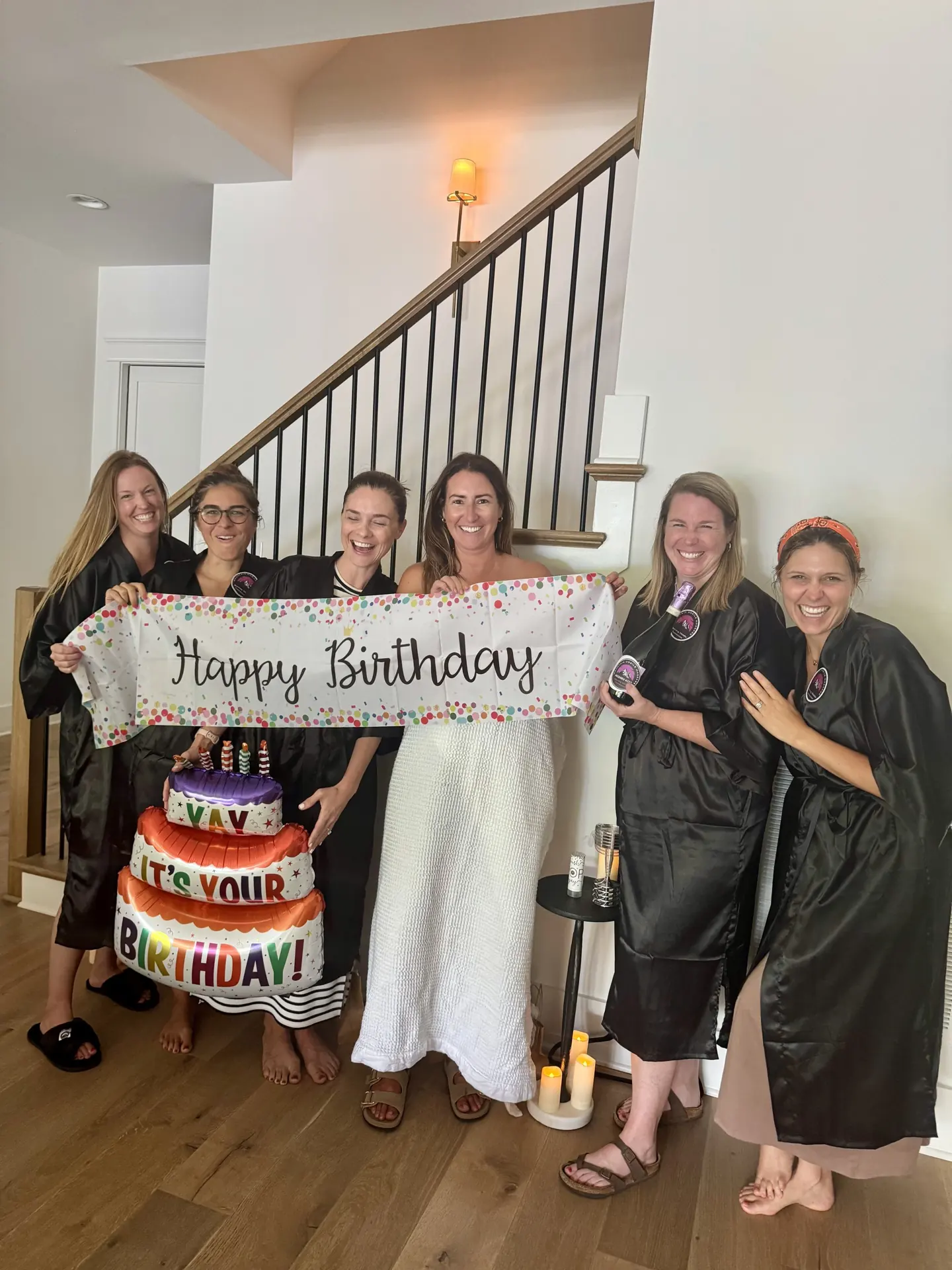 Guests posing together at a birthday celebration.